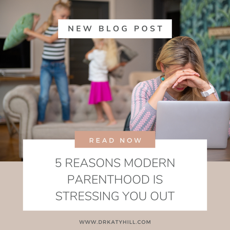 Woman suffering parental stress, head in her hands over a laptop while her children play noisily in the background