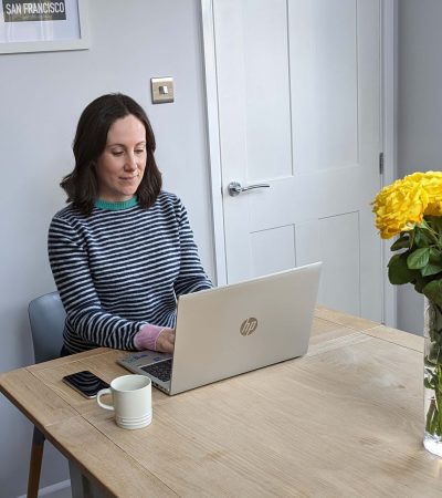 Dr Katy Hill working on her laptop, providing online therapy for stressed out parents