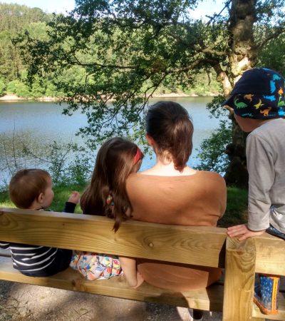 Dr Katy Hill with her three children looking at a reservoir