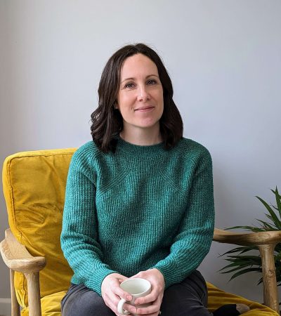 Dr Katy Hill in her therapy chair smiling